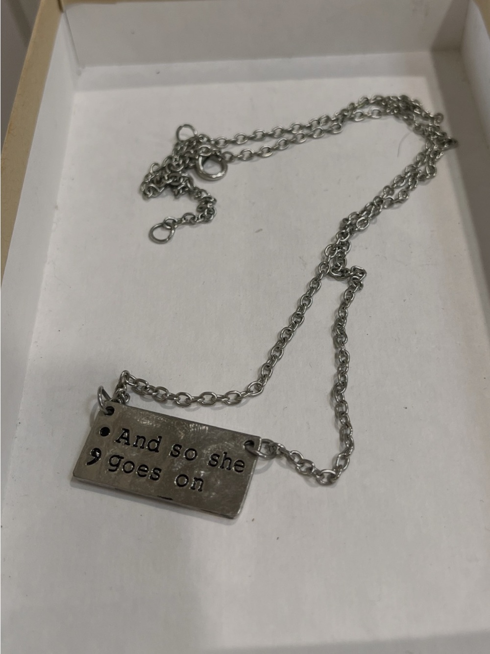 Stamped Quote Silver Pendant Necklace - "And so she goes on"